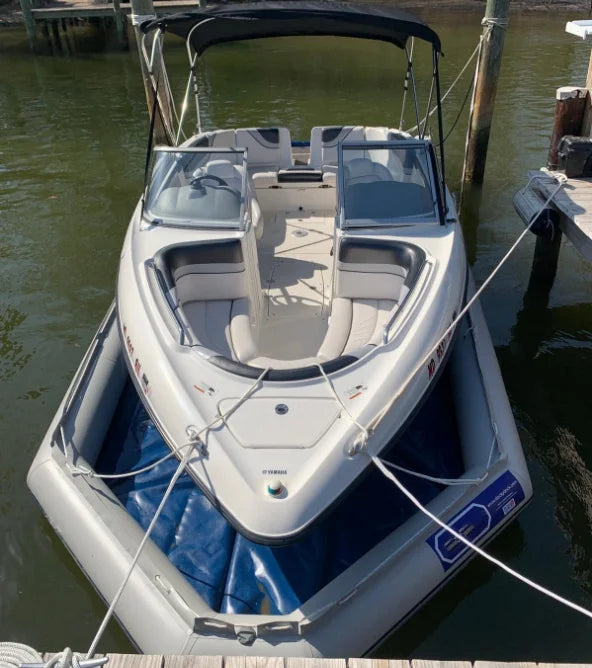 Inflatable Boat Dry Dock supporting a powerboat inside the blue floor basin