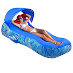 Inflatable Canopy Lounger in royal blue with a reclining woman, raised canopy and leaf-print sides.