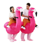 Inflatable Flamingo Costume worn by two adults side by side, showing matching pink birds and pretend rider legs.