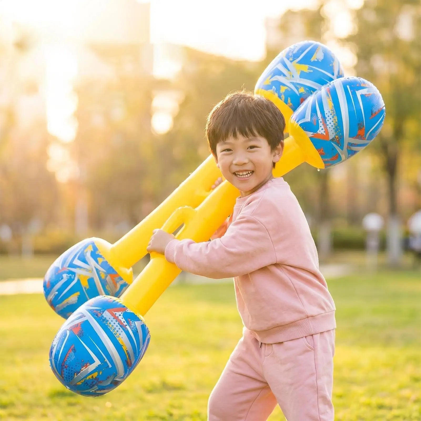 Inflatable Gladiator Baton Set — child carrying both batons outdoors