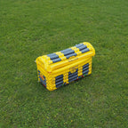 Inflatable Treasure Chest Cooler closed on grass with the gold-yellow chest artwork visible