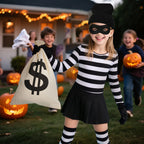 Child wearing Kids Burglar Costume Set and holding a money bag at an outdoor Halloween party with pumpkins.