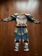 Kids Medieval Knight Costume laid flat from the back showing the full jumpsuit silhouette and printed details