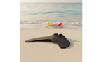 Kids Mermaid Swim Fin resting on beach sand in a low-angle view showing the black blade and raised foot openings.