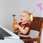 Kids Musical Toy Trumpet girl holding the orange and blue toy beside a piano