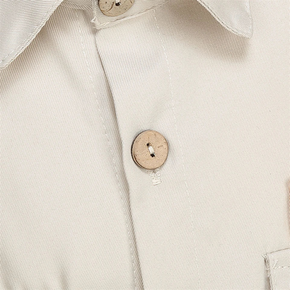 Kids Police Costume Set close-up of the beige shirt front button, buttonhole, and fabric texture.