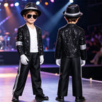 Kids Pop Star Costume Black Set shown from the front and back on a stage, with striped bottoms and gloves.