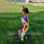 Kids Rainbow Pull Game Mat with rainbow fabric gathered around a standing child during outdoor pocket play