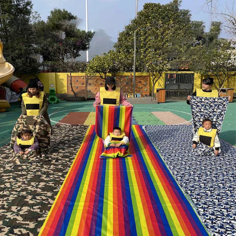 Kids Rainbow Pull Game Mat in the middle of a playground group activity with separate long fabric tracks