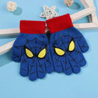 Pair of blue kids spider web gloves with red ribbed cuffs and yellow eye graphics on a light blue background.
