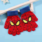 Pair of red kids spider web gloves with blue ribbed cuffs and yellow eye graphics on a light blue background.