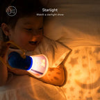 Kids Story Projector Lantern held by a child in bed, casting a warm star pattern across the bedding.