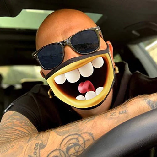 Laughing Mouth Face Mask worn with dark sunglasses, showing oversized cartoon teeth and a red tongue.