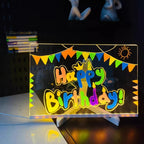 LED Acrylic Writing Board glowing with Happy Birthday lettering and colorful bunting on its stand