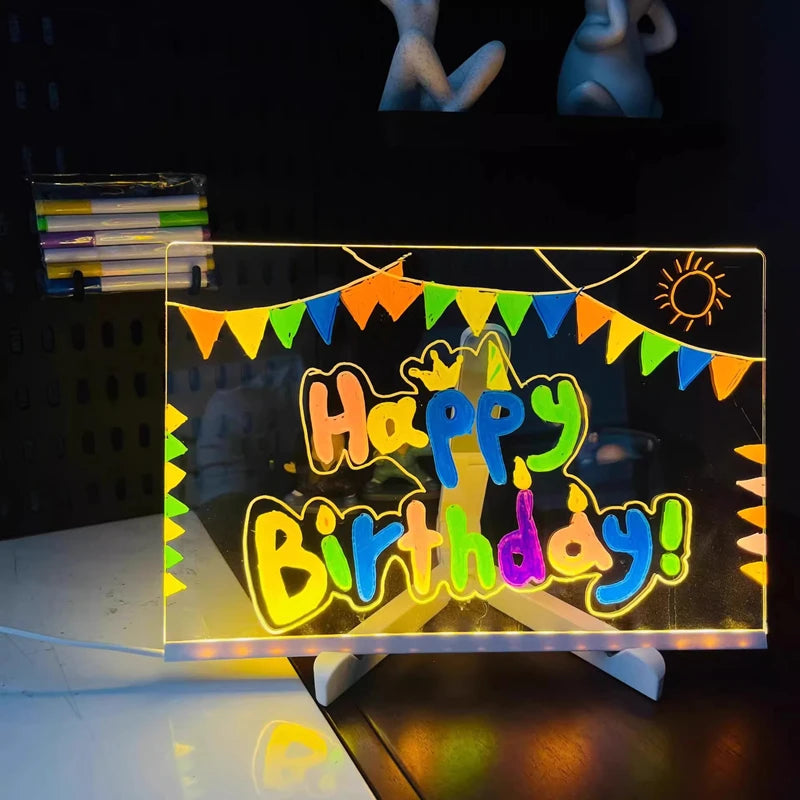 LED Acrylic Writing Board glowing with Happy Birthday lettering and colorful bunting on its stand