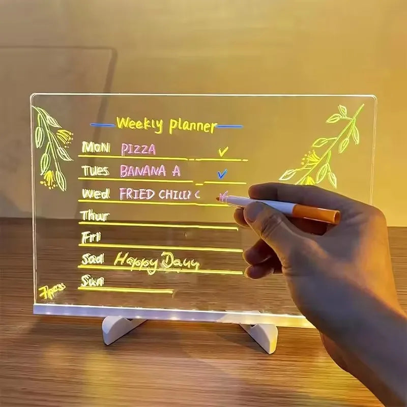 LED Acrylic Writing Board used as a weekly planner while a hand writes with a colored pen