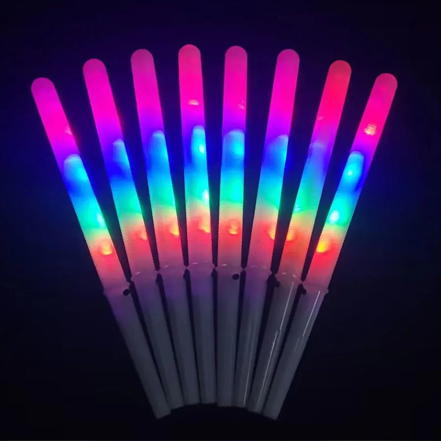 LED Cotton Candy Sticks fanned out in the dark, showing bright pink, blue, green and red illumination.