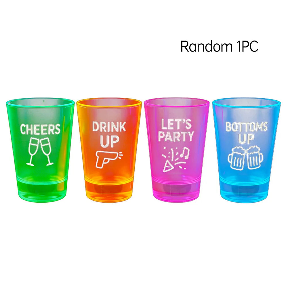 LED Flashing Shot Glasses in green, orange, pink, and blue with printed party slogans on a white background