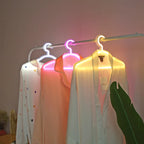 LED Glowing Clothes Hanger supplier styling view with three illuminated hangers and sheer clothing