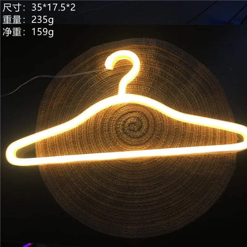 LED Glowing Clothes Hanger in warm white on a woven mat, with supplier dimensions and weight labels