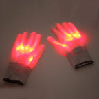 LED Glowing Skeleton Gloves red-lit pair on a gray surface, showing bright finger lights and cuff buttons.