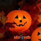 Luminous Halloween Balloons glowing orange among autumn leaves in a seasonal display