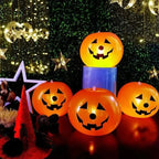 Luminous Halloween Balloons arranged as four glowing pumpkins in a styled Halloween party scene