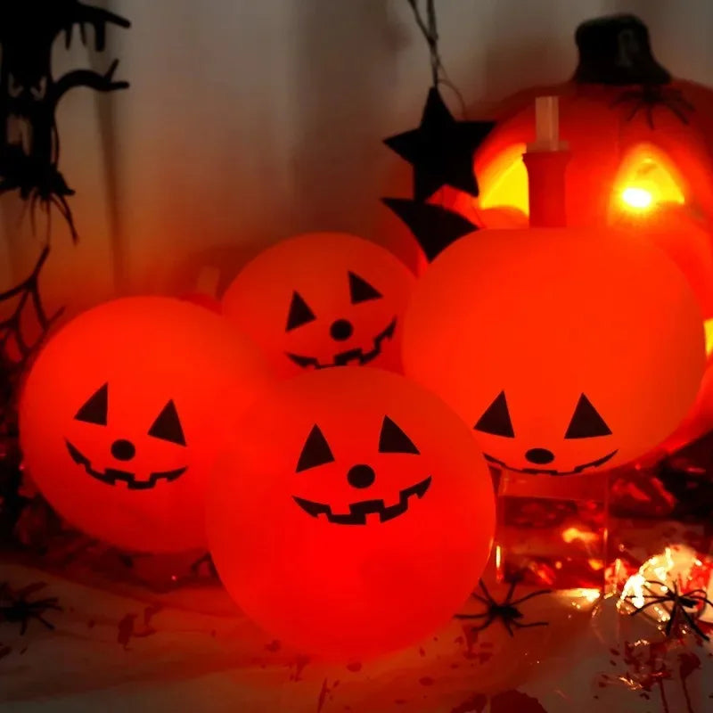 Luminous Halloween Balloons glowing as four jack-o’-lantern pumpkins in a Halloween table display