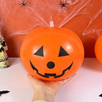 Luminous Halloween Balloons inflated 10-inch pumpkin balloon held in one hand for scale