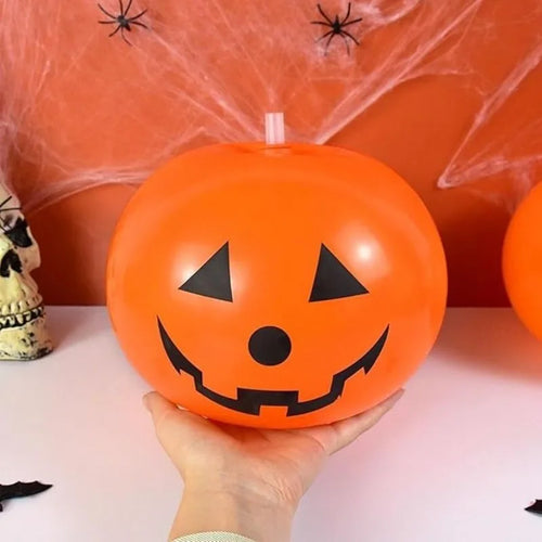Luminous Halloween Balloons inflated 10-inch pumpkin balloon held in one hand for scale