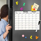 Magnetic Fridge Calendar on a dark refrigerator beside colorful magnets and a child peeking around the door.