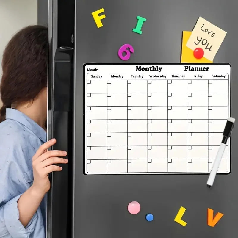 Magnetic Fridge Calendar on a dark refrigerator beside colorful magnets and a child peeking around the door.