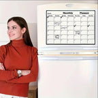 Magnetic Fridge Calendar with handwritten reminders on a white fridge beside a woman in an orange top.