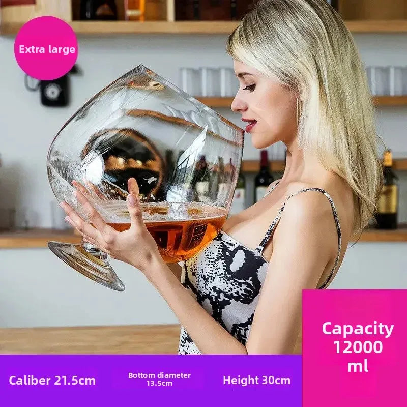 Mega Sized Wine Glass 12 L held by a woman, with capacity and rim, base, and height measurements.