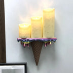 Melting Ice Cream Shelf in Colorful finish displaying three glowing pillar candles