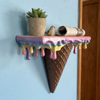 Melting Ice Cream Shelf in Colorful finish holding a plant and small decorative pieces