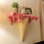 Melting Ice Cream Shelf in Pink shown close up with a plant, jar, and framed accent