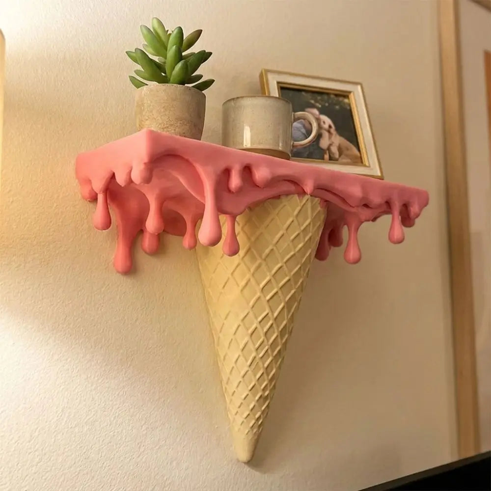 Melting Ice Cream Shelf in Pink shown close up with a plant, jar, and framed accent