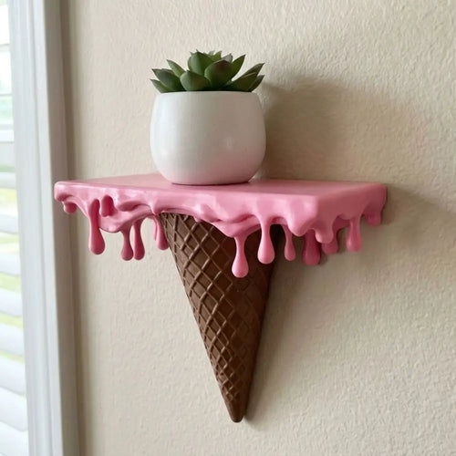 Melting Ice Cream Shelf in Pink mounted on a wall and styled with a small potted plant