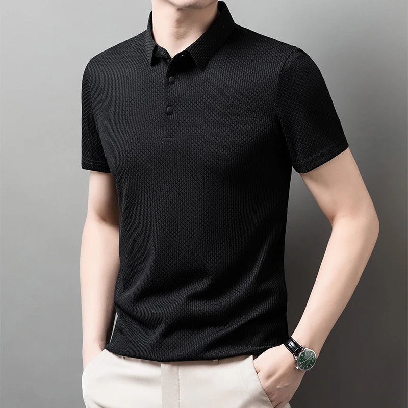 Man wearing the black Men's Valor Textured Polo in an angled pose