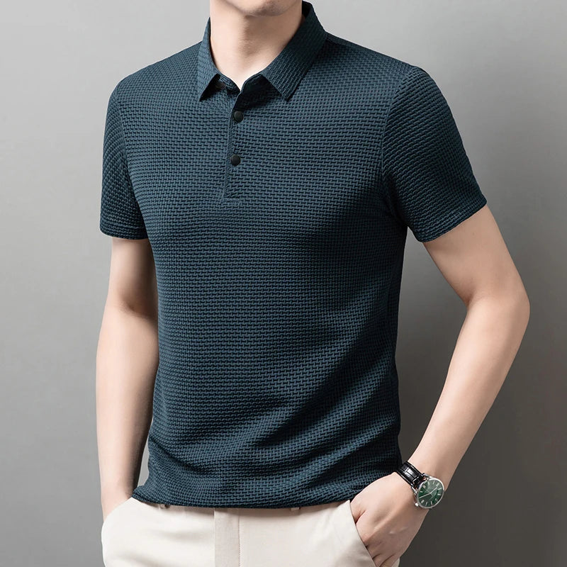 Man wearing the blue Men's Valor Textured Polo in an angled pose