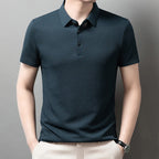 Man wearing the blue Men's Valor Textured Polo with light trousers
