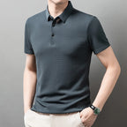 Man wearing the gray Men's Valor Textured Polo in an angled pose