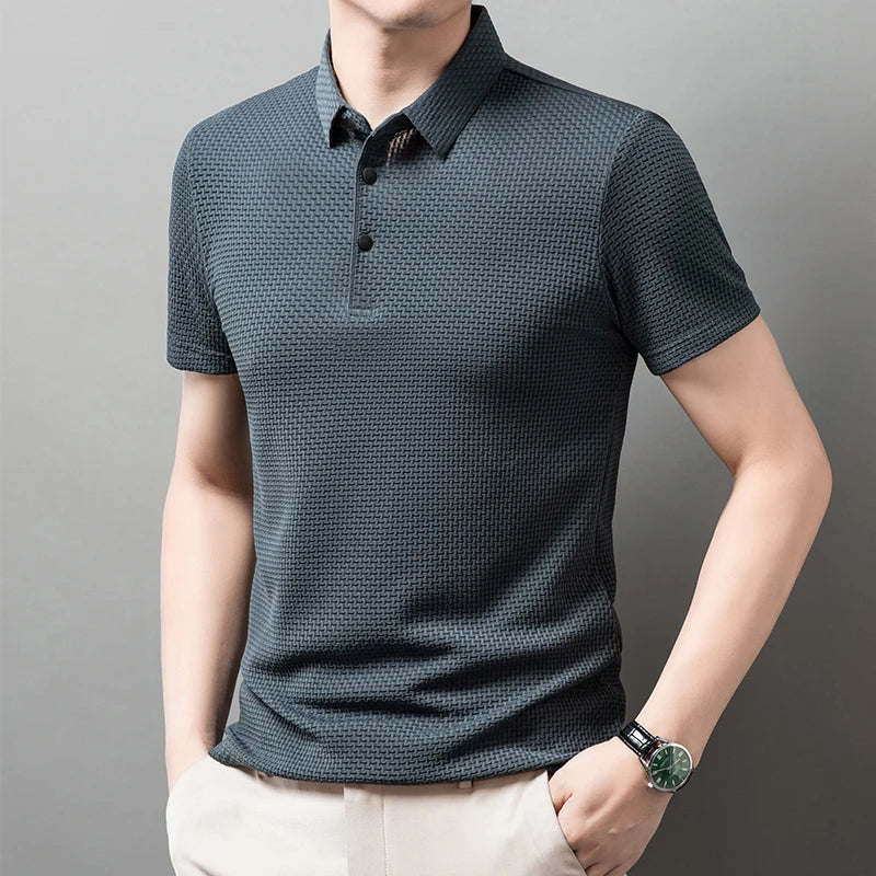 Man wearing the gray Men's Valor Textured Polo in an angled pose