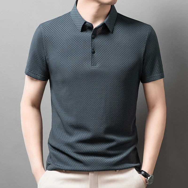 Man wearing the green Men's Valor Textured Polo with light trousers