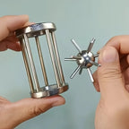 Metal Cage Challenge with the removable spiked metal ball held beside the empty cylindrical cage