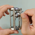 Metal Cage Challenge held in both hands while the spiked ball is guided through the steel cage