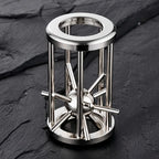 Metal Cage Challenge standing upright on a dark surface with the spiked ball inside the cage