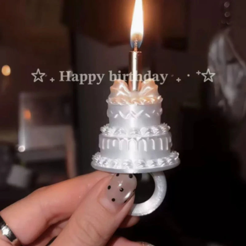 Mini Birthday Cake Ring in white held beneath a lit candle, with a happy birthday message behind it.