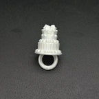 Mini Birthday Cake Ring in white viewed from the front on a dark surface, with the circular band visible.